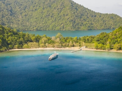 View of the coral reef and bay from the top of Gili Lawa Darat, one of the many islands scattered through out the Komodo Nation Park in Indonesia. Also note the strong current entering the channel.